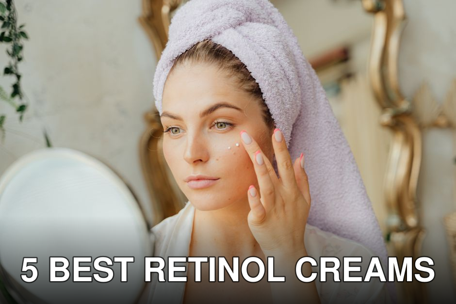Woman with head towel applying moisturizer in front of mirror indoors.
