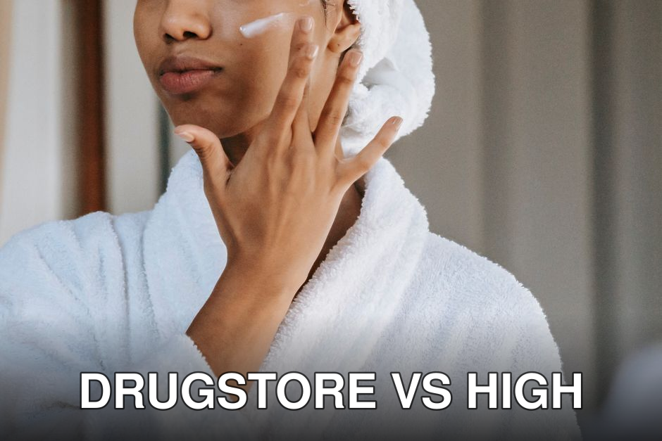Crop anonymous female in white bathrobe with towel on head applying facial moisturizing cream on face while standing in bathroom