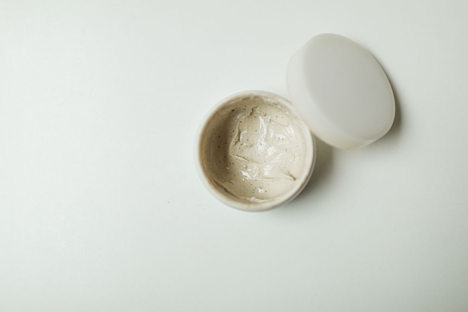 Close-up of an opened cream jar, ideal for skincare product representation.