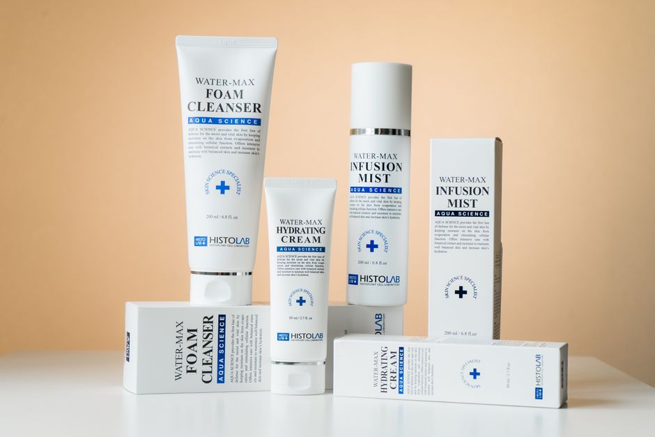 Elegant showcase of Water-Max skincare products including cleanser, cream, and mist on a white surface.