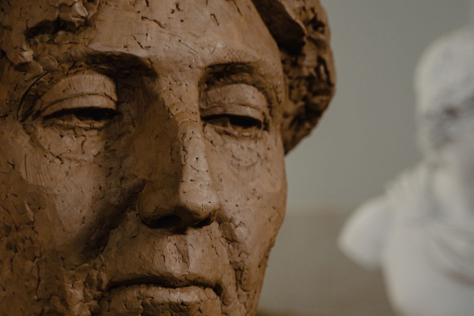 Detailed close-up of a handmade clay sculpture showcasing intricate features.