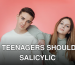 Portrait of stylish teenagers against a pink studio backdrop.