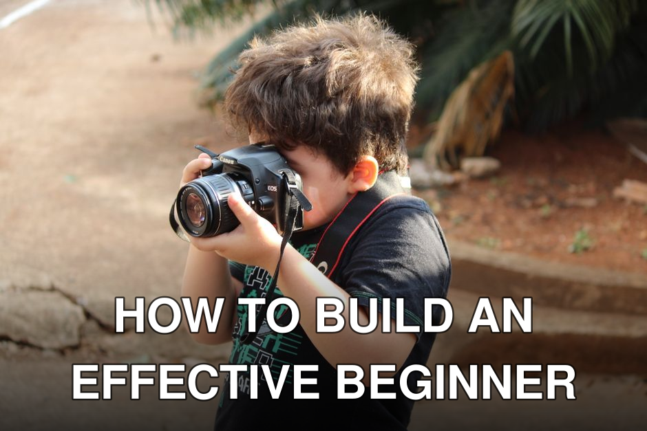 Young boy experimenting with photography using a DSLR camera in an outdoor setting.