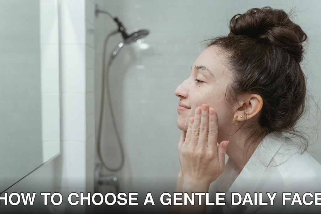 A woman applying facial cream in a mirror for her skincare routine in a bathroom.