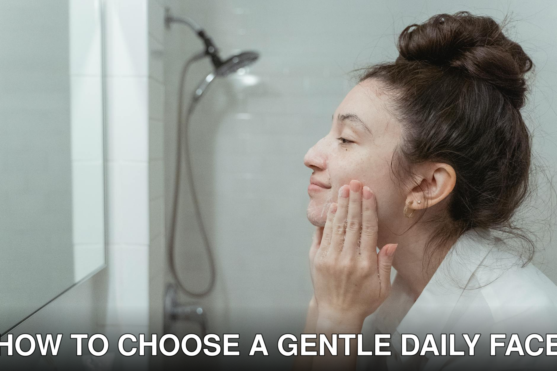 A woman applying facial cream in a mirror for her skincare routine in a bathroom.