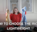 A woman in a red sweater deciding between clothes in a messy room.