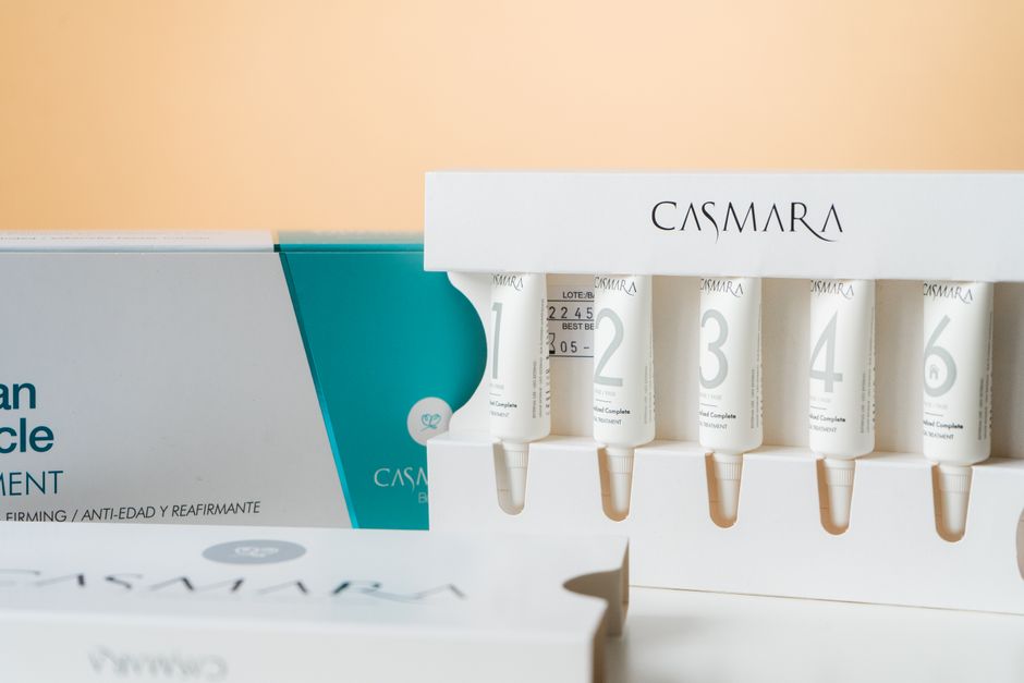 Elegant display of Casmara beauty products with skincare serums in a clean, modern setup.