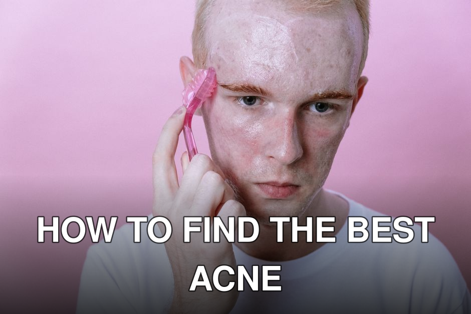 Young man using a pink facial roller on his face against a pink background.