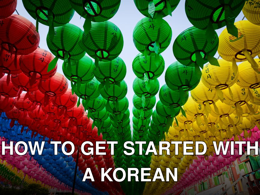 Vibrant colored paper lanterns adorn a city street, creating a festive atmosphere.