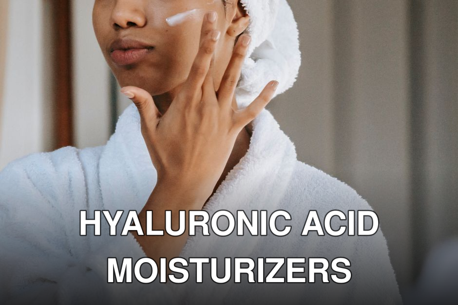 Crop anonymous female in white bathrobe with towel on head applying facial moisturizing cream on face while standing in bathroom