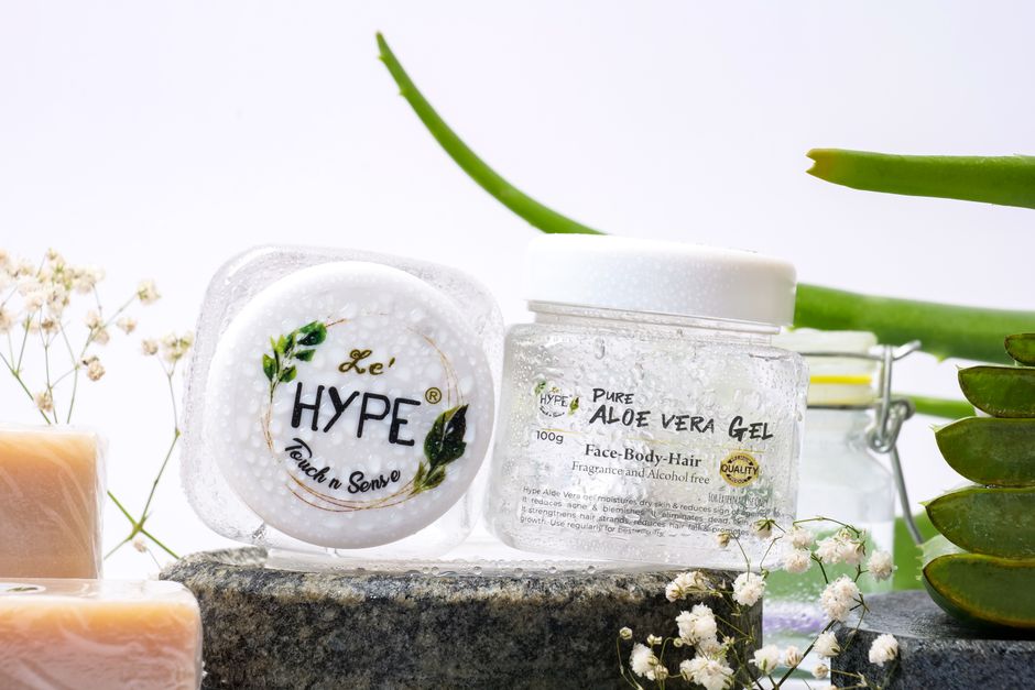 Aloe vera skincare products on a natural stone setting with greenery.