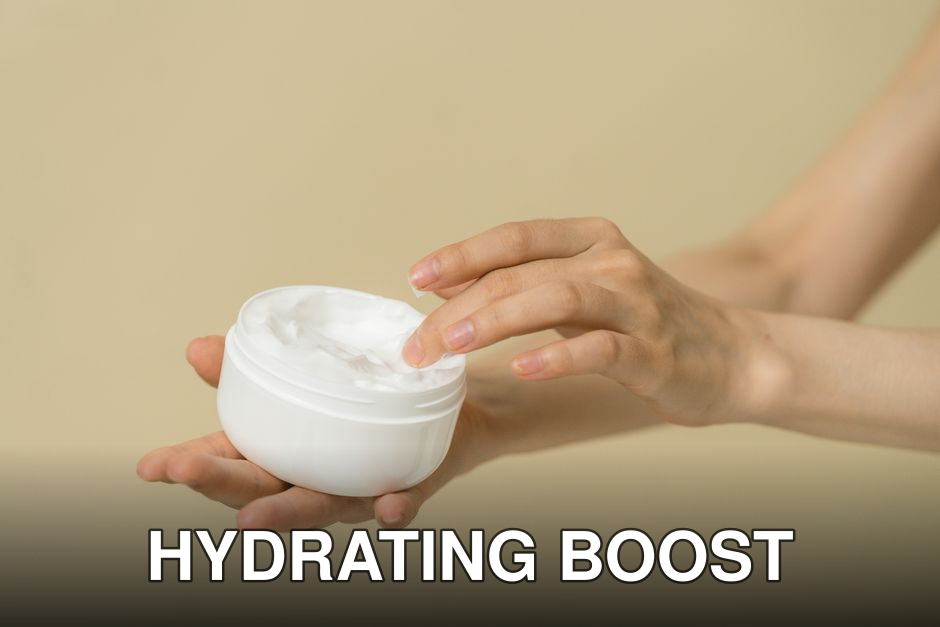 Close-up of female hands applying moisturizer from an open jar, highlighting skincare and self-care routine.