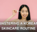 Smiling woman with braces applying facial serum on a pink background, highlighting skincare routine.