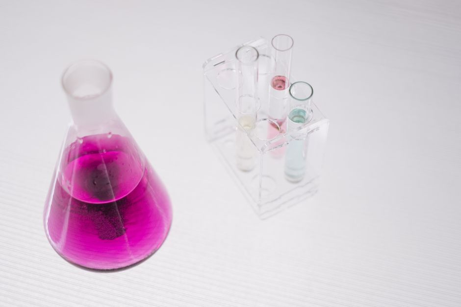 A vibrant chemistry setup with flasks and colored liquids in a lab.
