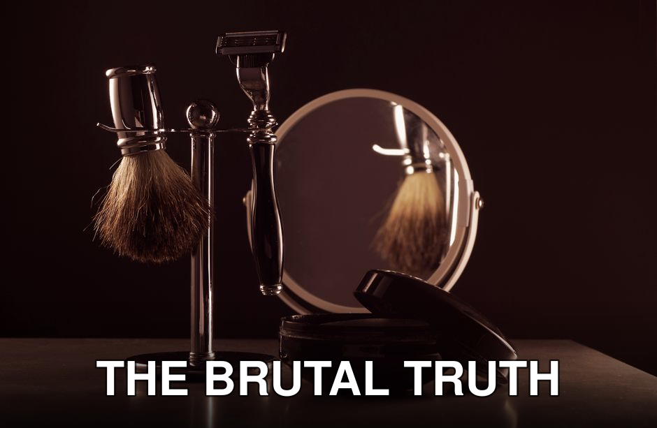 Stylish shaving set featuring a brush, razor, and mirror on a table, ideal for men's grooming.