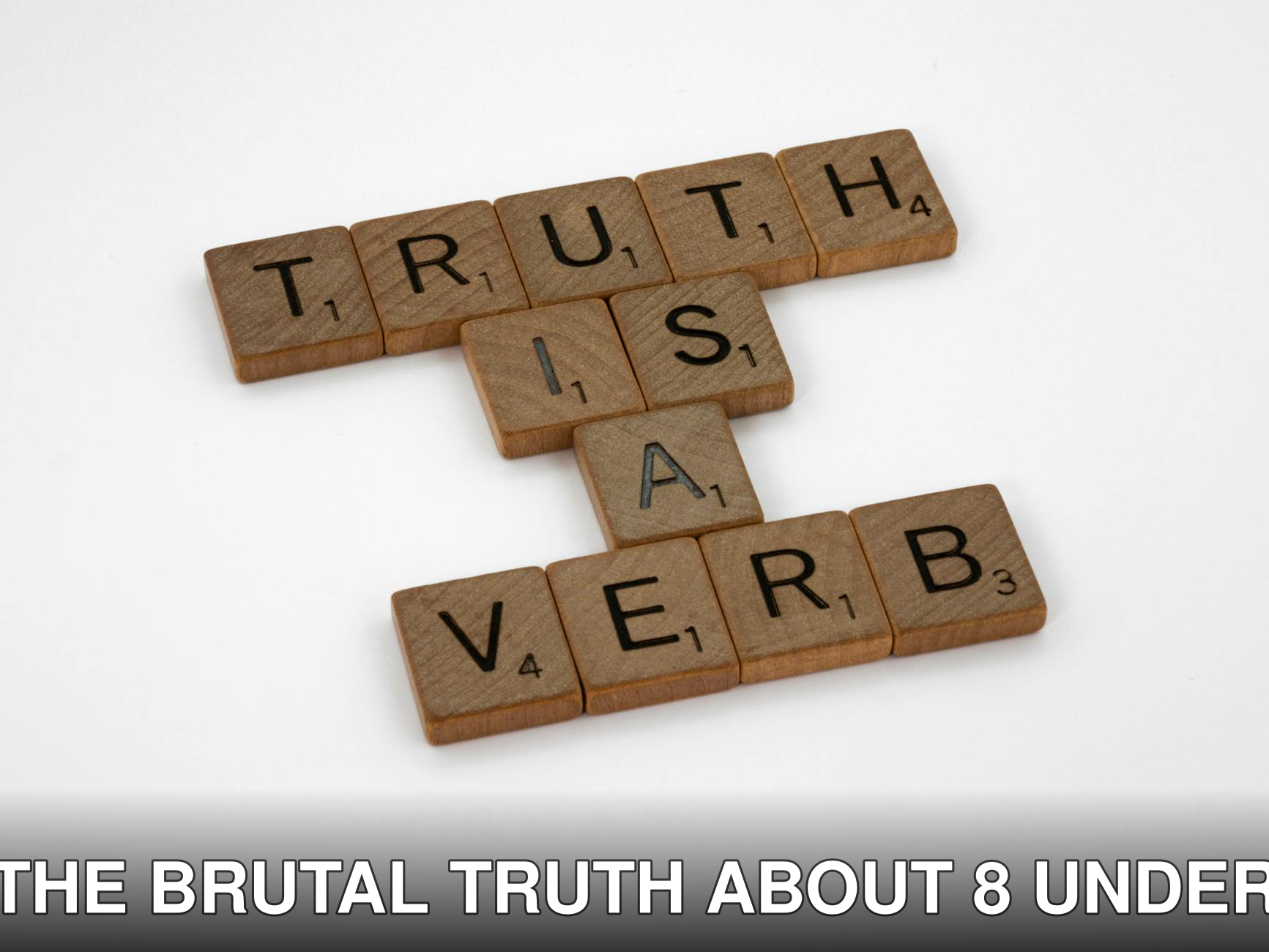 Scrabble tiles arranged on a white background spelling 'Truth is a Verb' for creative representation.