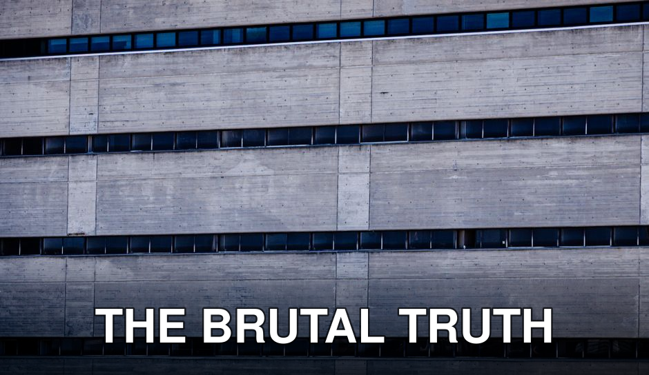 Detailed view of a concrete building facade showcasing brutalist architecture style.
