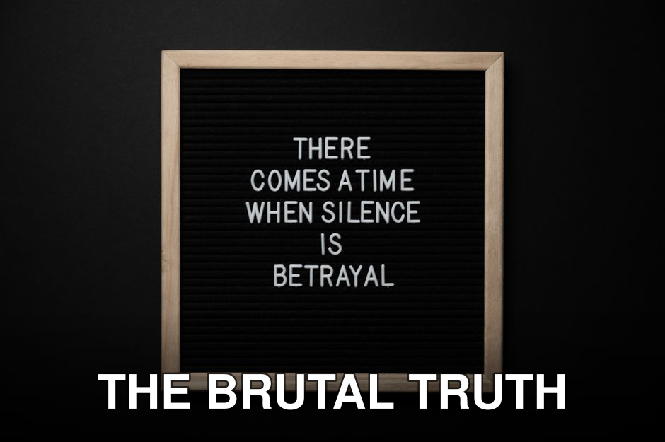 From above chalkboard with THERE COMES A TIME WHEN SILENCE IS BETRAYAL inscription on black background