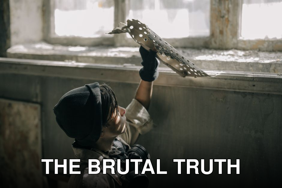 A young man examines decayed materials in a post-apocalyptic setting, symbolizing survival.