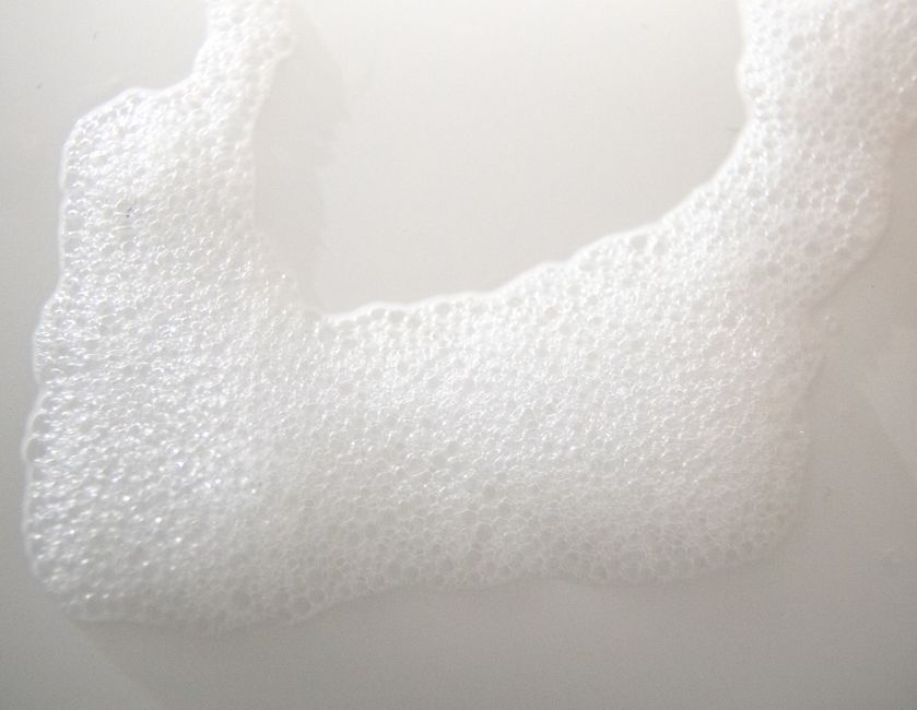 Top view of backdrop representing froth flows with small bubbles spreading on white background
