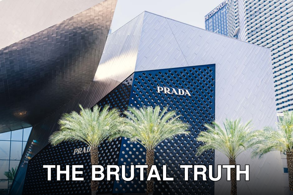 Contemporary architecture of the Prada storefront on Las Vegas Strip with palm trees and unique design.