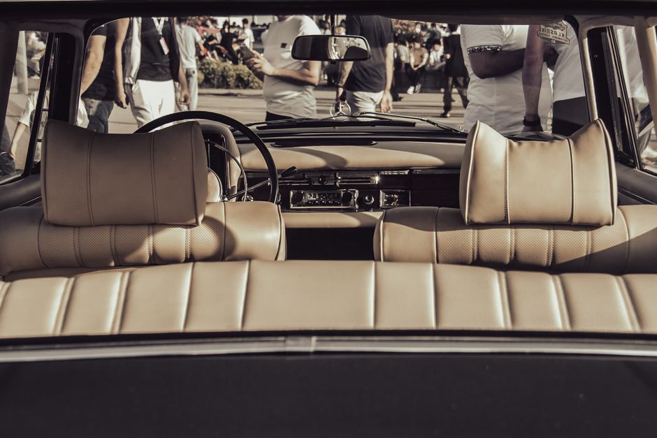 A classic vintage car interior featuring leather seats and dashboard, perfect for automotive enthusiasts.