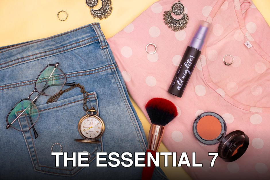 A stylish flat lay highlighting fashion essentials and makeup items on a polka-dot shirt.