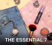 A stylish flat lay highlighting fashion essentials and makeup items on a polka-dot shirt.