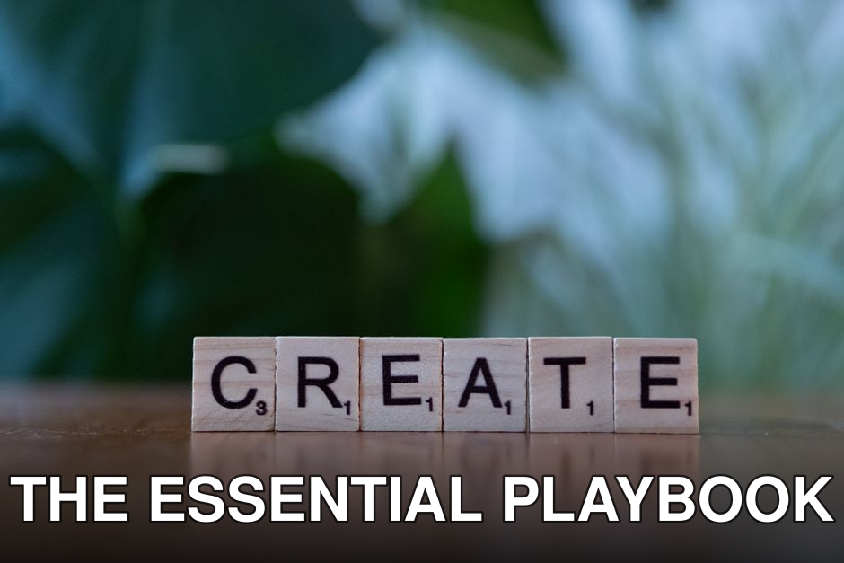 Wooden letter blocks spelling 'CREATE' against a blurred green background.