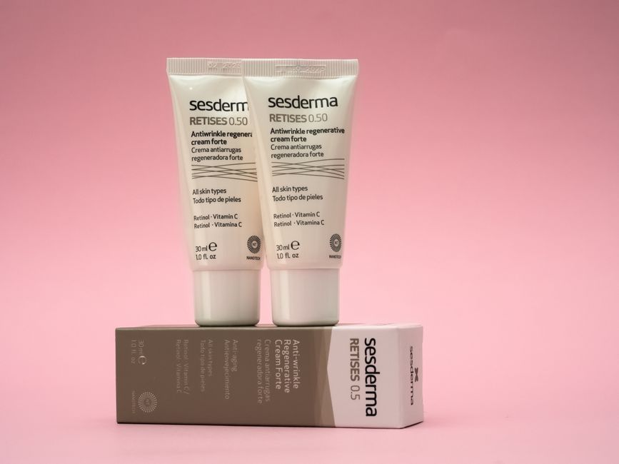 Two Sesderma Retises antiwrinkle creams on a pink background, emphasizing skincare.
