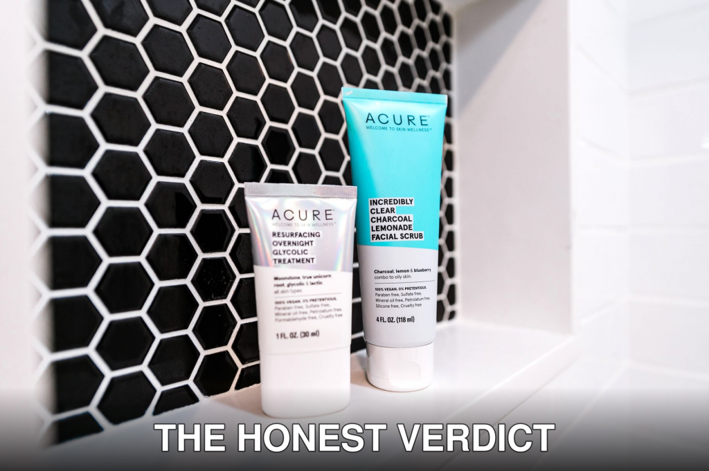 Close-up of Acure skincare products on a stylish black hexagonal tile background.