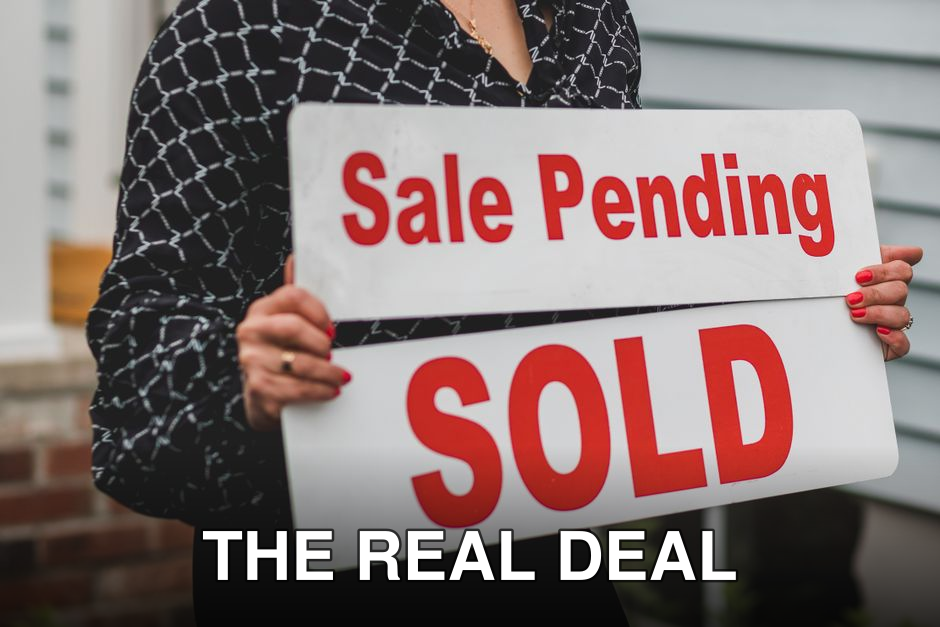 A businesswoman holding 'Sale Pending' and 'Sold' signs indicating a successful real estate transaction.