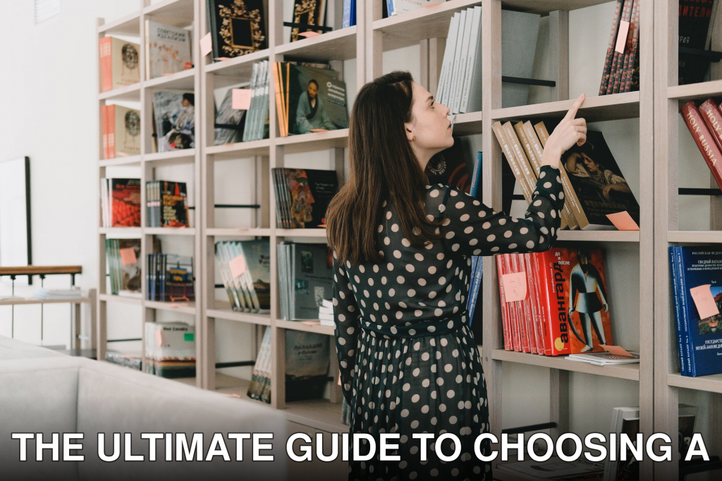 Back view of young female standing near bookcase and selecting literature for leisure