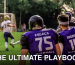 Back view of American football players watching a match on a sunny day.