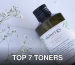 Close-up of a Skinergy toner bottle surrounded by delicate flowers, showcasing its natural essence.