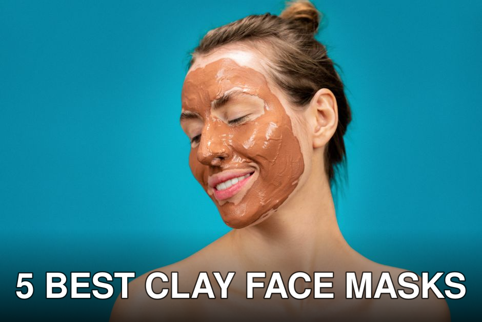A woman smiles while applying a clay mud mask for skincare treatment.