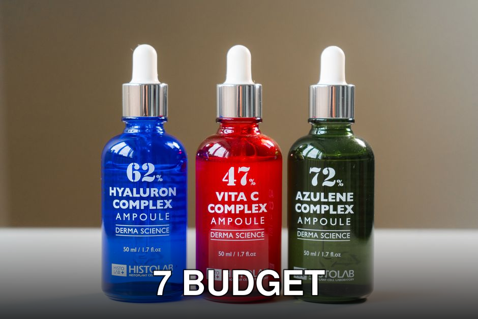 Three vibrant ampoule bottles for skincare solutions, ideal for cosmetic product showcases.