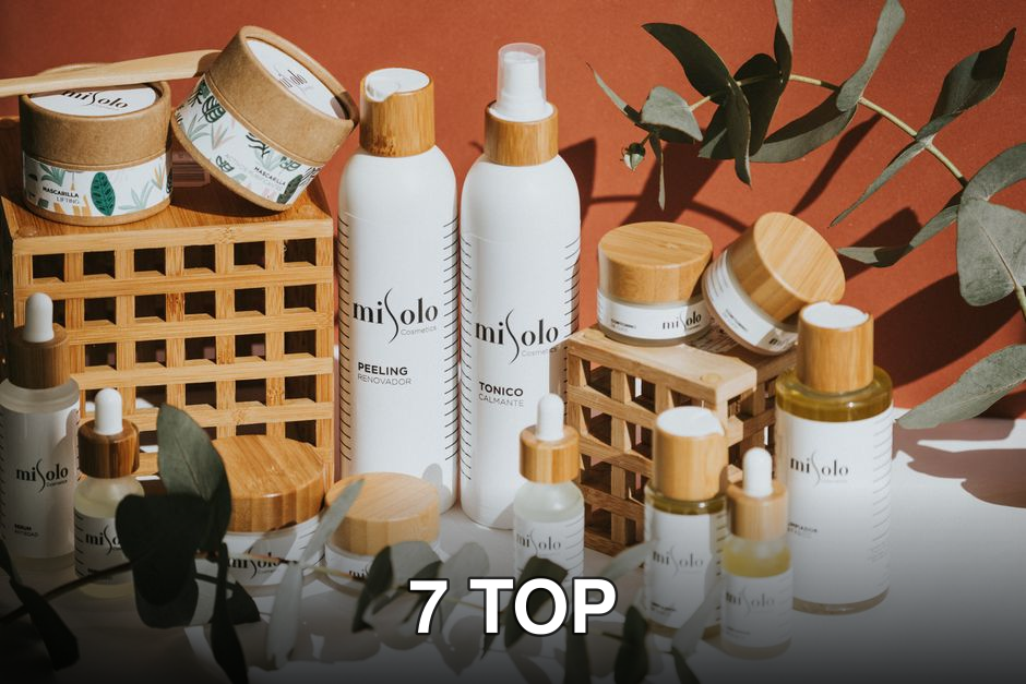 Aesthetic display of eco-friendly cosmetic products featuring eucalyptus leaves and bamboo elements.