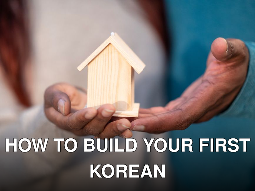 Close-up of hands holding a miniature wooden house, symbolizing home ownership and real estate investment.
