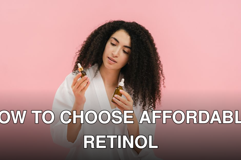 A woman with curly hair in a white robe examines two cosmetic oil bottles against a pink background.