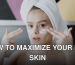 A young woman with a towel on her head applying face cream in a skincare routine.