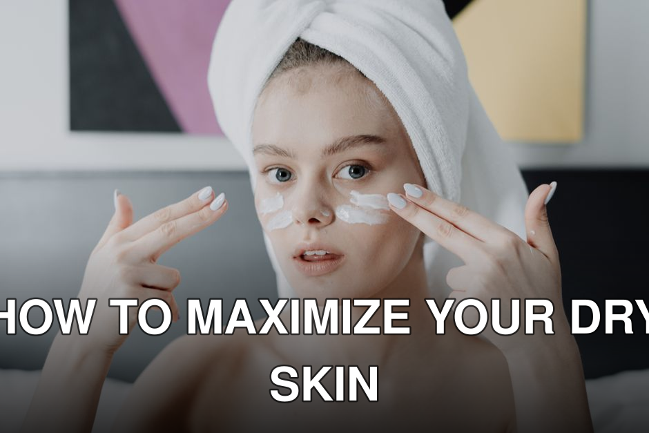A young woman with a towel on her head applying face cream in a skincare routine.