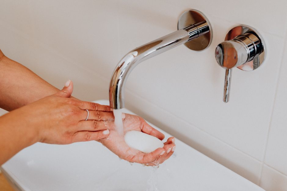 Clean hands with soap under running water promoting hygiene.