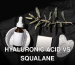 Elegant beauty product arrangement featuring a serum dropper bottle and gua sha on a black background.