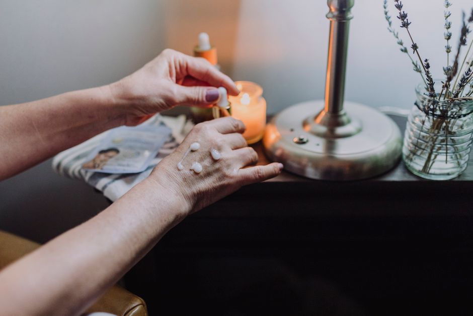 A serene setup showcasing a skincare routine with creams and aromatherapy candles, enhancing self-care and wellness.