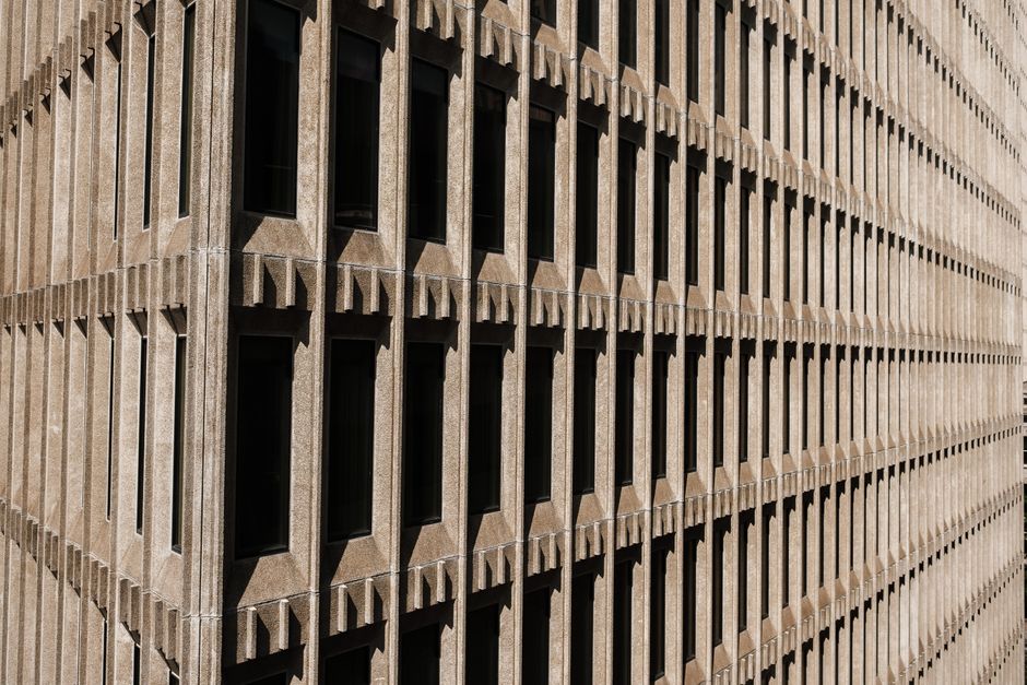 Close-up of a geometric concrete building facade with light and shadow play.