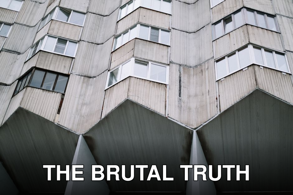 Close-up view of a geometric urban building facade highlighting its modern concrete design.