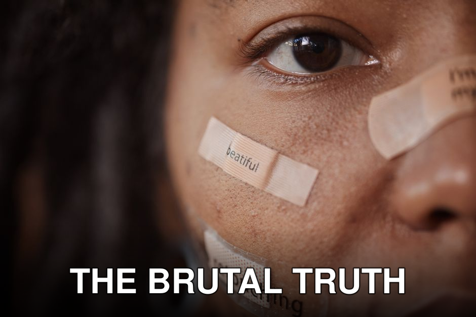 Close-up of a woman's face with band-aids featuring text, reflecting beauty and self-image themes.