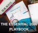 Financial charts and office supplies on a wooden desk, featuring a magnifying glass and US Mail lunchbox.