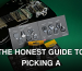Black electric guitar with variety of guitar picks on a green background.